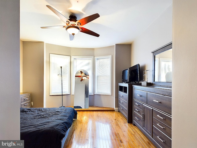 bedroom featuring light hardwood / wood-style floors, multiple windows, and ceiling fan