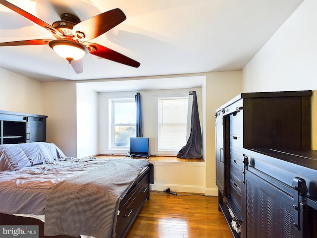 bedroom with light hardwood / wood-style flooring and ceiling fan