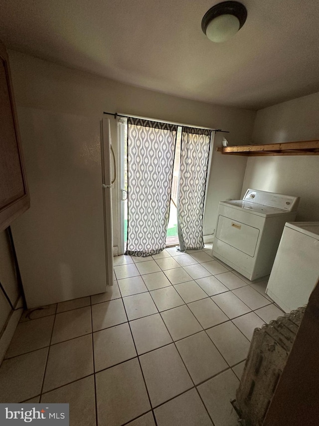 bathroom featuring tile patterned flooring and washer and dryer