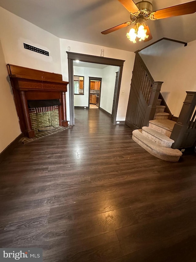 unfurnished living room featuring dark hardwood / wood-style floors and ceiling fan