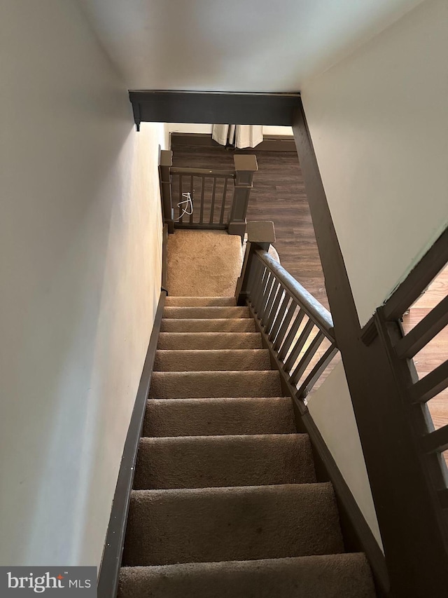 stairs featuring hardwood / wood-style floors