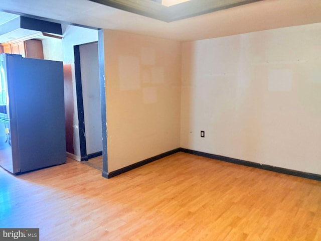 unfurnished room with light wood-type flooring