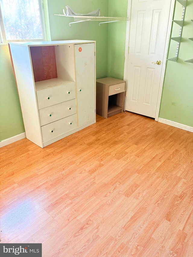 unfurnished bedroom featuring light hardwood / wood-style floors and a closet