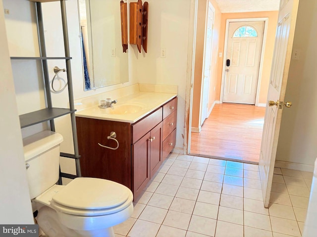 bathroom with hardwood / wood-style floors, vanity, and toilet