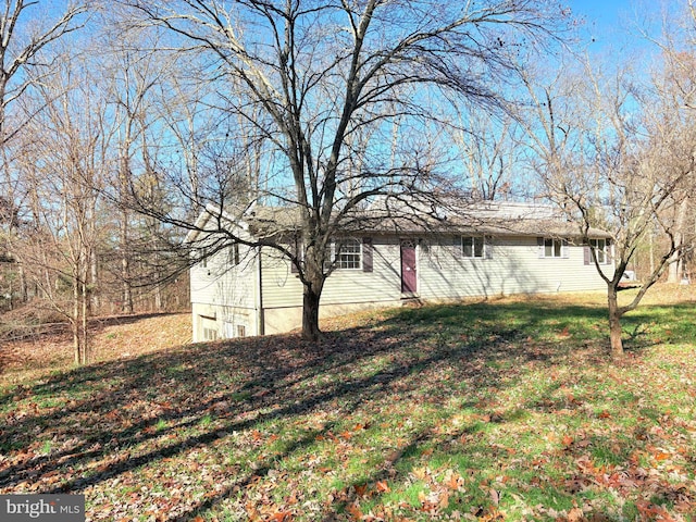 view of home's exterior with a lawn