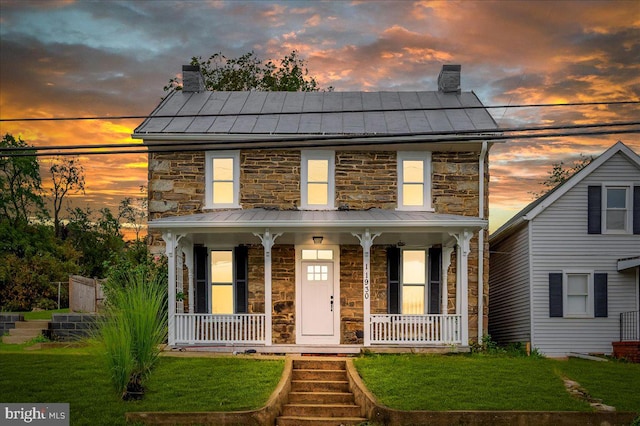 view of front facade featuring a porch and a lawn