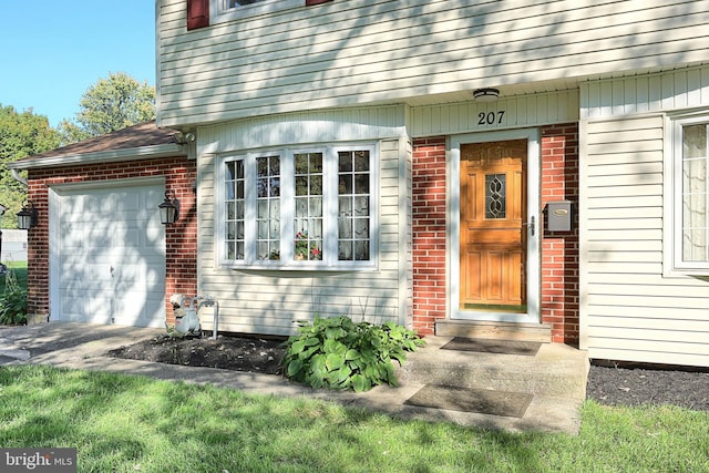 doorway to property with a garage