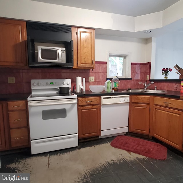 kitchen with backsplash, sink, and white appliances