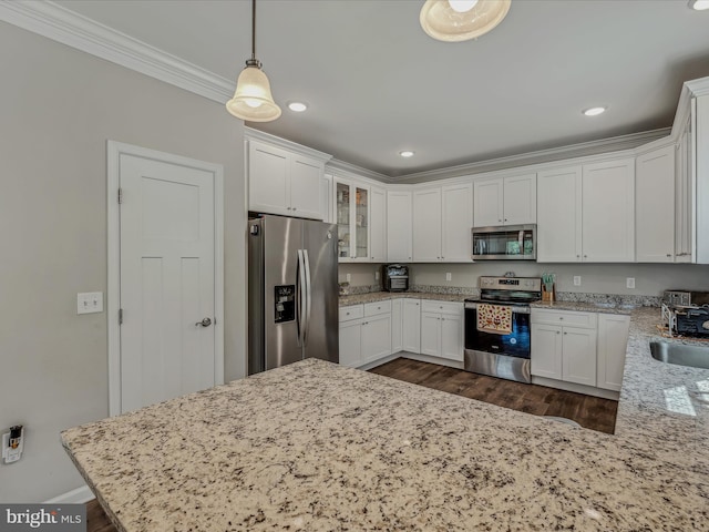 kitchen featuring decorative light fixtures, stainless steel appliances, dark wood-type flooring, and white cabinetry