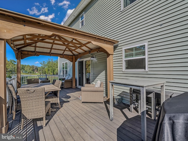 wooden terrace featuring a gazebo