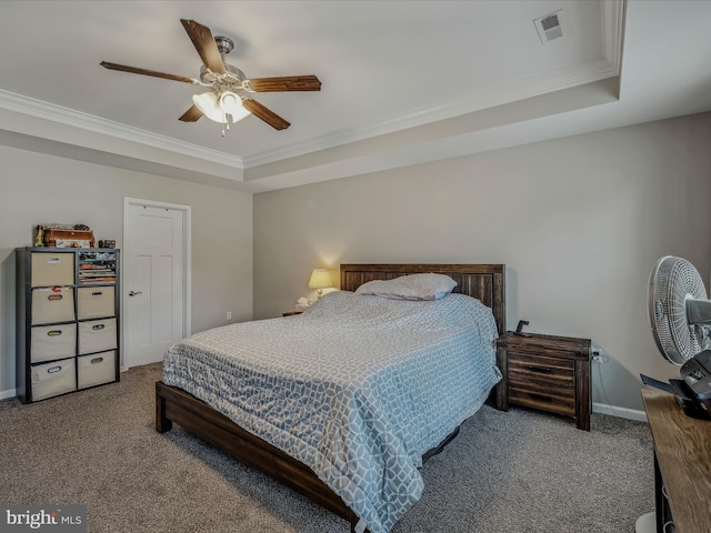 bedroom with ceiling fan, a raised ceiling, crown molding, and carpet