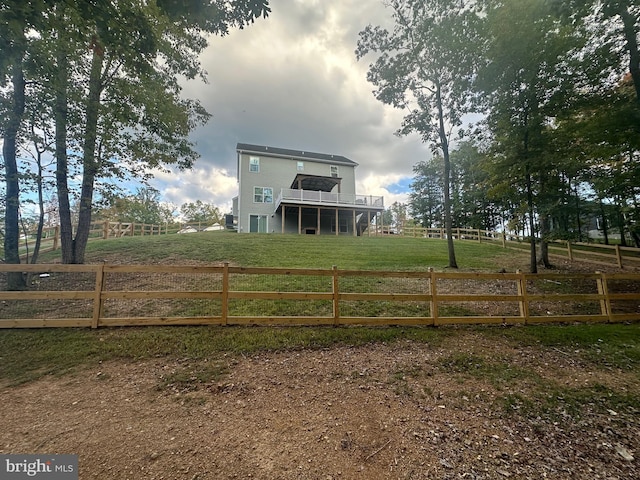 view of gate with a yard and a rural view