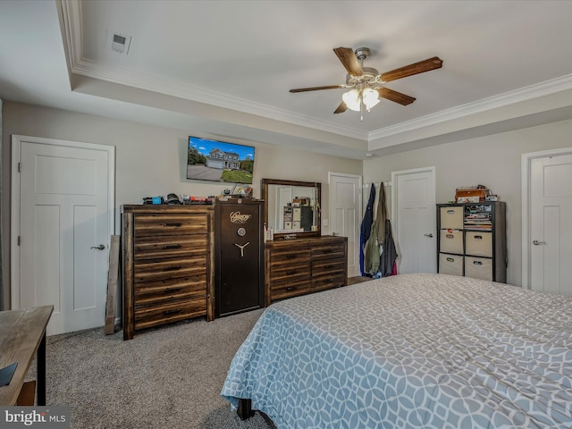 bedroom with crown molding, ceiling fan, light colored carpet, and a raised ceiling