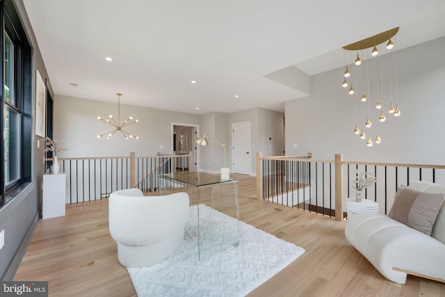 living room featuring a chandelier and light hardwood / wood-style floors