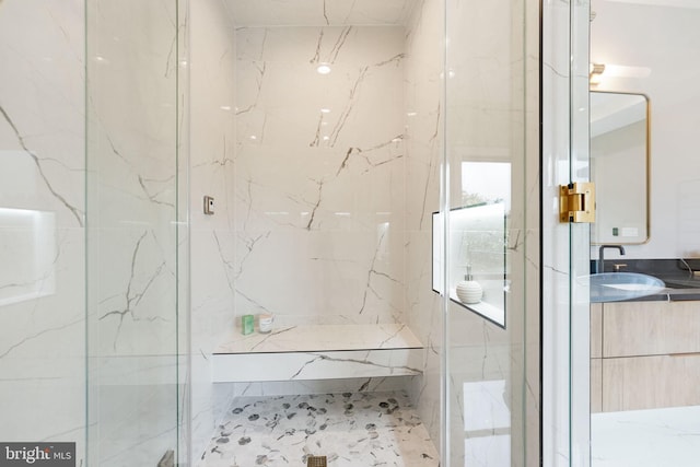 bathroom featuring vanity and a shower with shower door