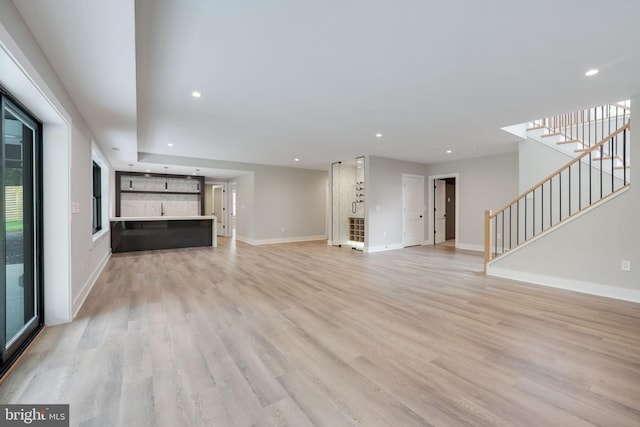 unfurnished living room featuring light hardwood / wood-style flooring