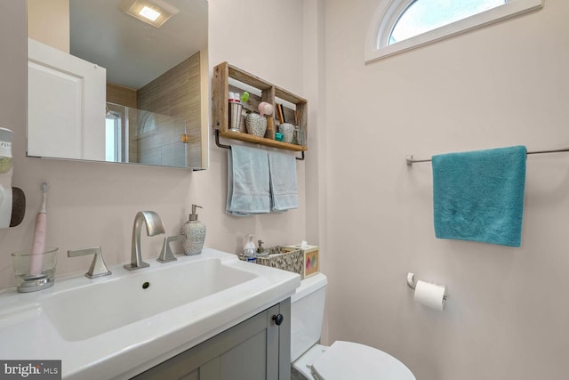 bathroom featuring vanity and toilet