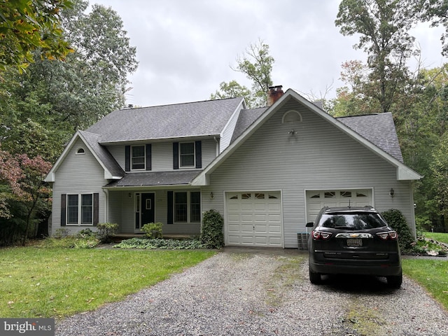 front of property featuring covered porch, a front yard, and a garage