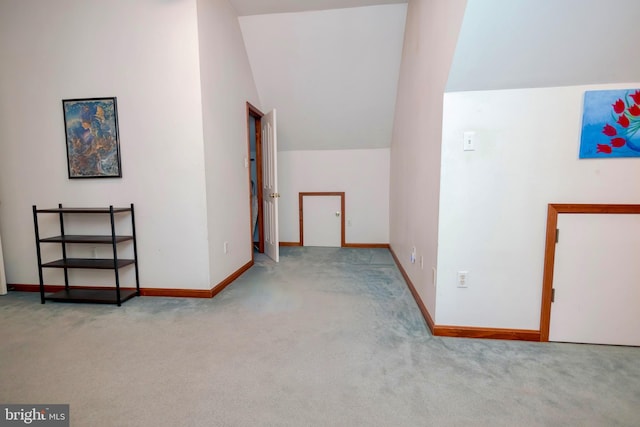 additional living space with light carpet and lofted ceiling