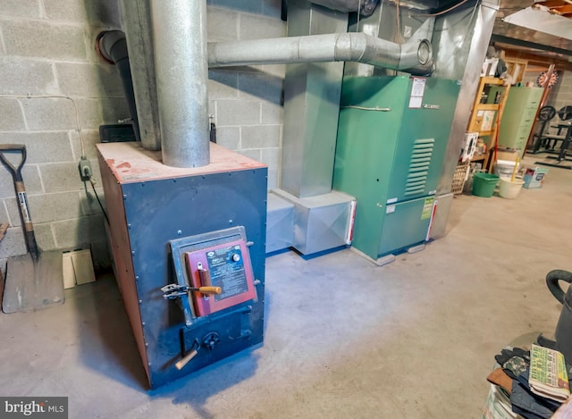 utility room featuring gas water heater and heating unit