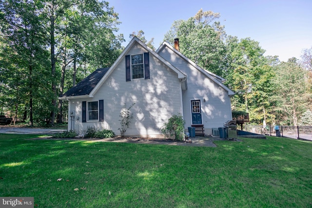 view of home's exterior with a yard