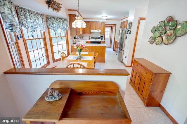 kitchen featuring pendant lighting, black electric range oven, light tile patterned floors, kitchen peninsula, and stainless steel refrigerator