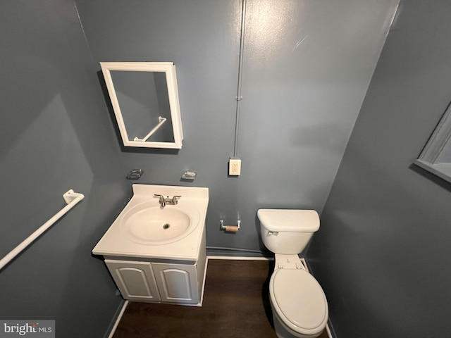 bathroom featuring hardwood / wood-style floors, vanity, and toilet