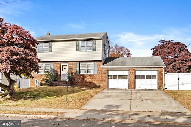 view of front of home featuring a front yard and a garage