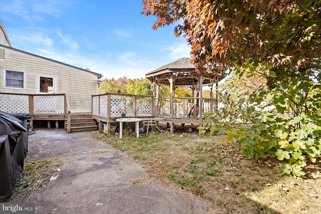 exterior space with a wooden deck and a gazebo