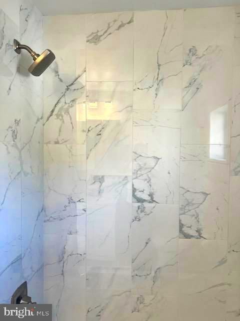 interior space with tiled shower