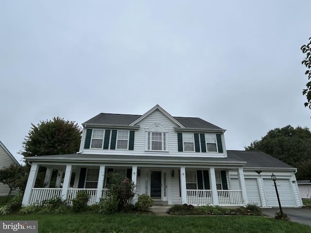 view of front facade with a garage and covered porch