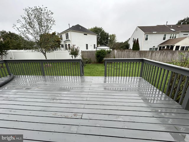 wooden deck with a lawn