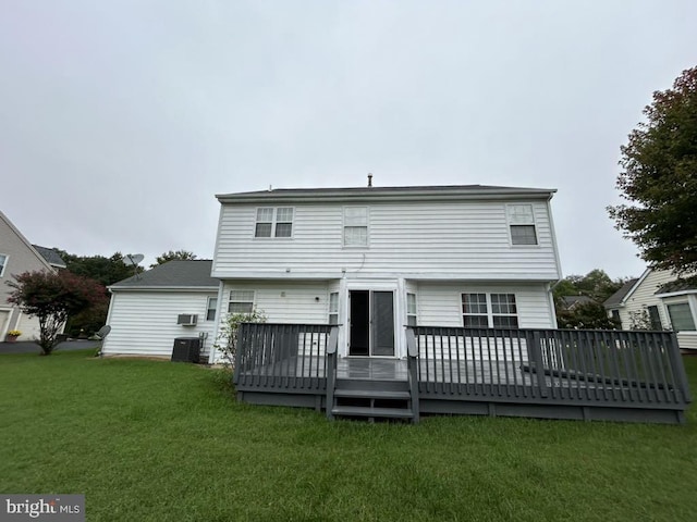 rear view of house featuring central AC unit, a deck, and a yard