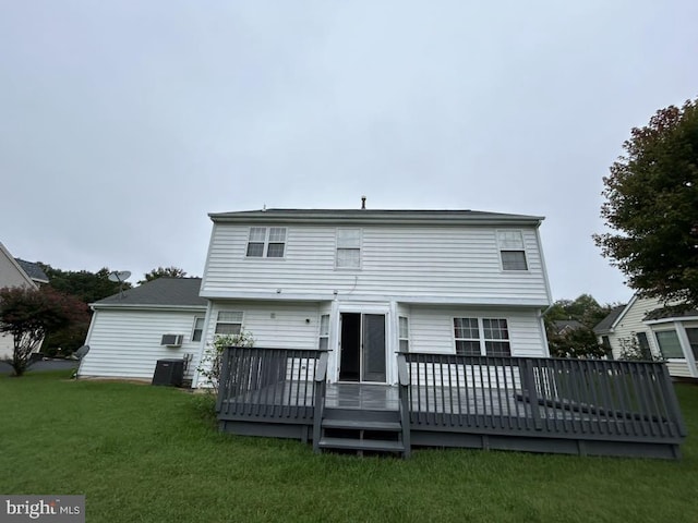 back of house featuring central AC, a deck, and a yard