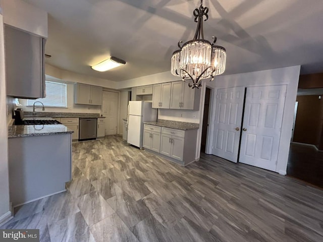 kitchen featuring gray cabinetry, white refrigerator, dishwasher, pendant lighting, and a chandelier