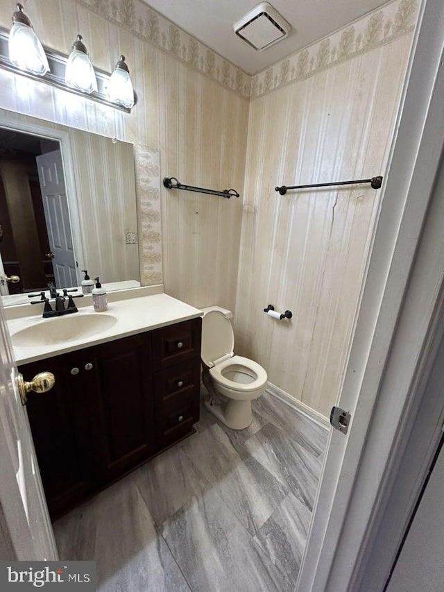 bathroom featuring vanity and toilet