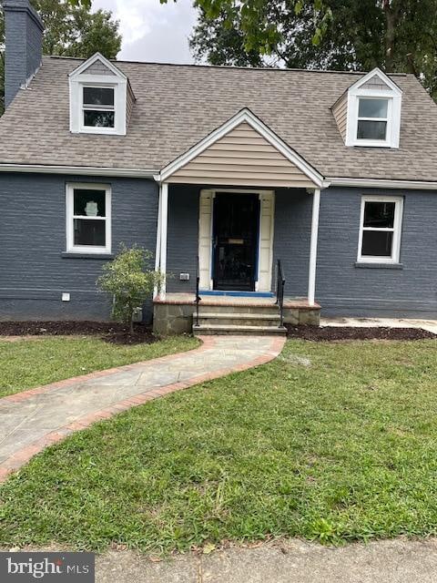 cape cod home with covered porch and a front yard