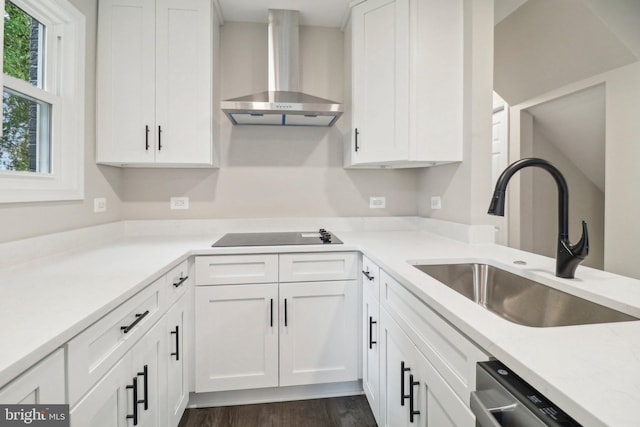 kitchen featuring sink, wall chimney range hood, white cabinetry, black electric stovetop, and dark hardwood / wood-style flooring