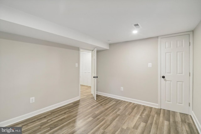 basement with hardwood / wood-style flooring