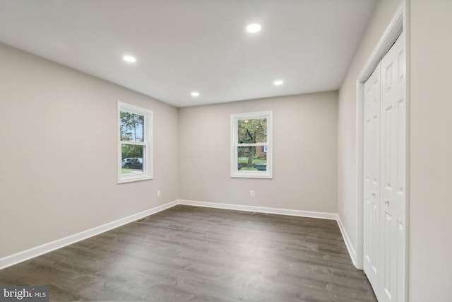 unfurnished bedroom featuring dark hardwood / wood-style flooring