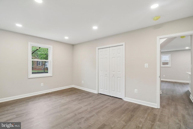 unfurnished bedroom featuring hardwood / wood-style flooring and a closet