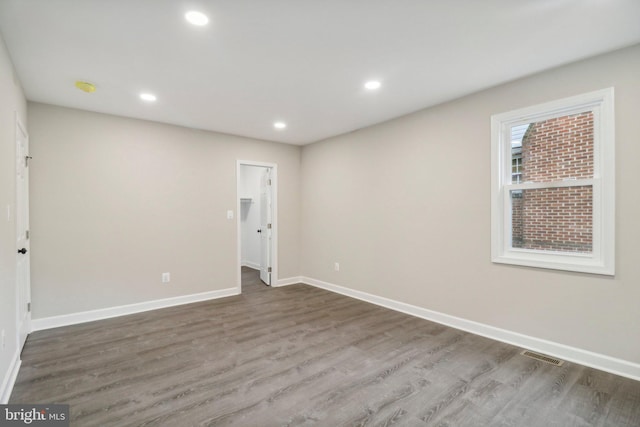 spare room with wood-type flooring