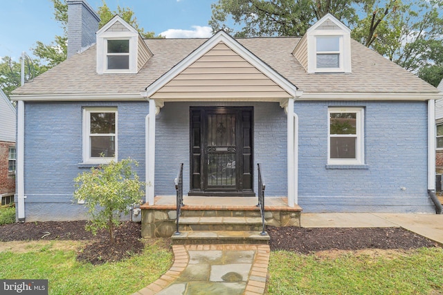 new england style home featuring covered porch