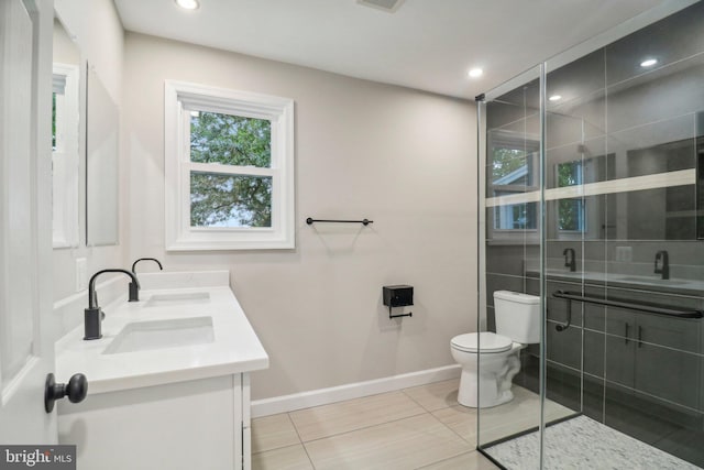 bathroom featuring vanity, a shower with shower door, toilet, and tile patterned flooring