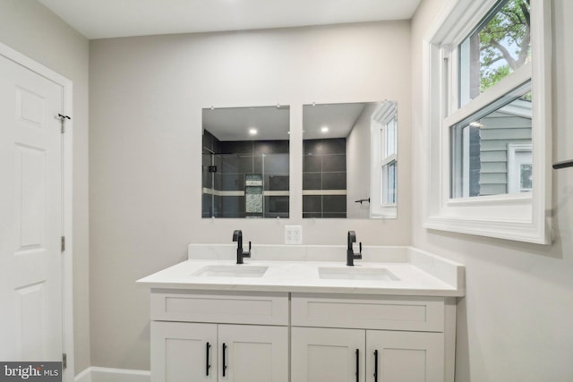 bathroom with vanity and a tile shower