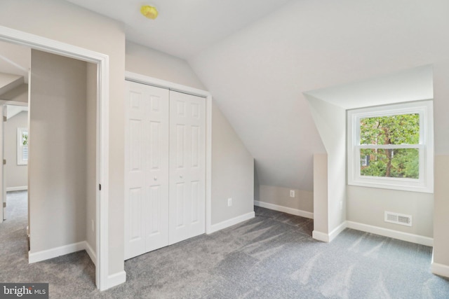 additional living space with carpet flooring and vaulted ceiling