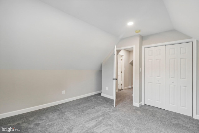 additional living space with lofted ceiling and dark colored carpet