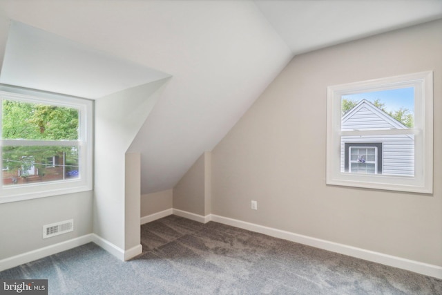 bonus room featuring carpet floors, vaulted ceiling, and plenty of natural light