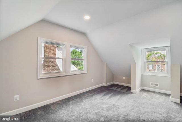 bonus room featuring carpet flooring and vaulted ceiling