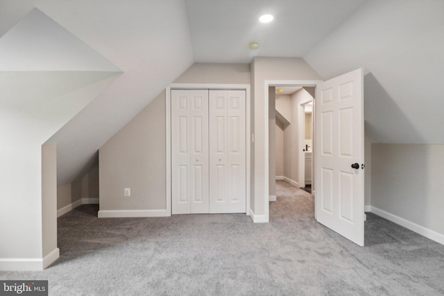 additional living space with light carpet and lofted ceiling